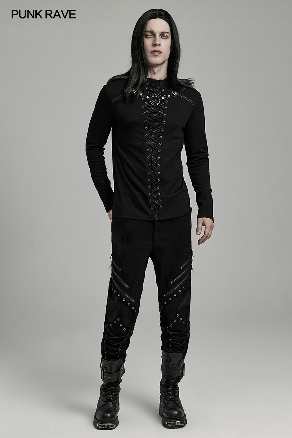 Punk style black lace-up long sleeve top with ring details, paired with edgy pants for a daring alternative fashion look.