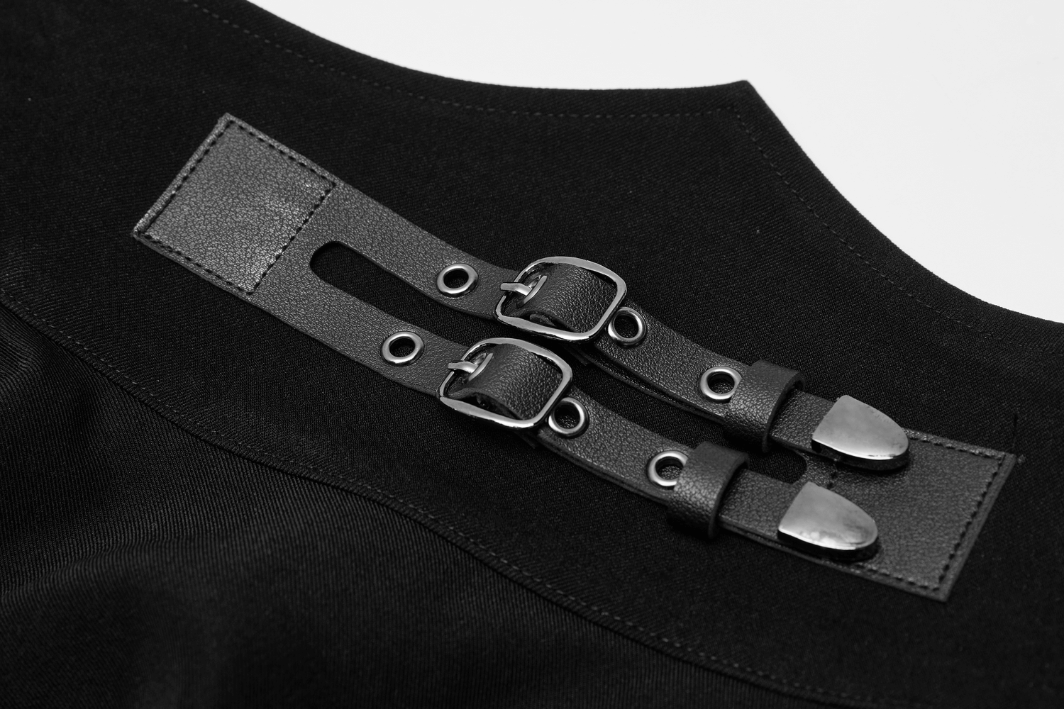Close-up of punk style black high-waist skirt with gunmetal buckle loops and detail.