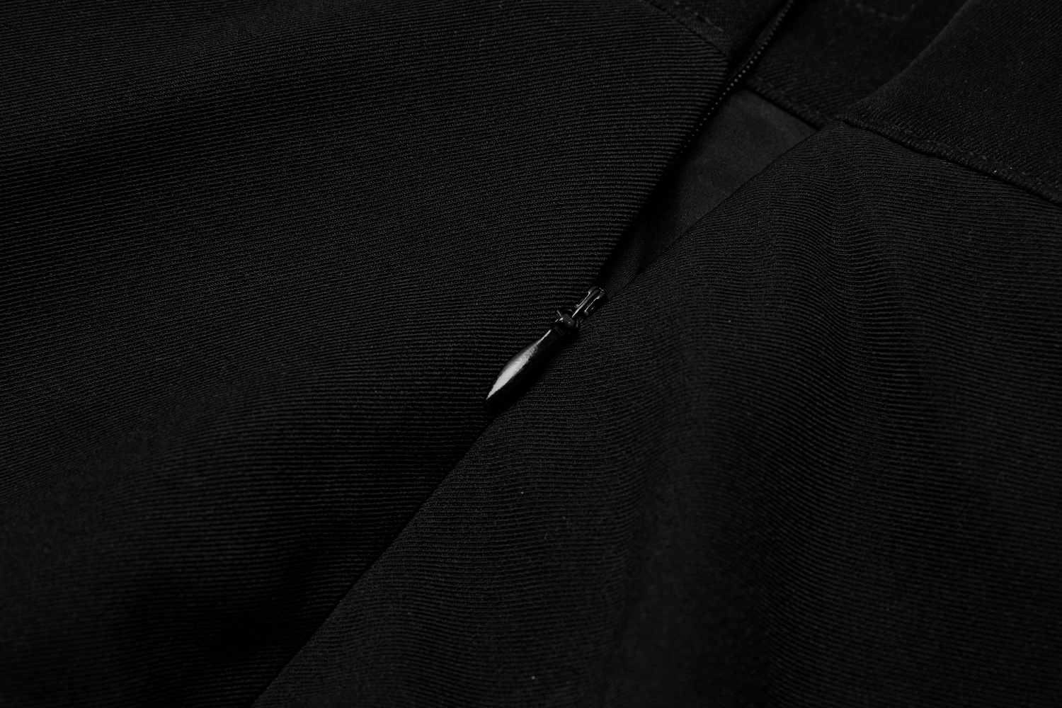 Close-up of the zipper on Nicola High-Waist Swing Skirt showcasing its sleek design and quality craftsmanship.