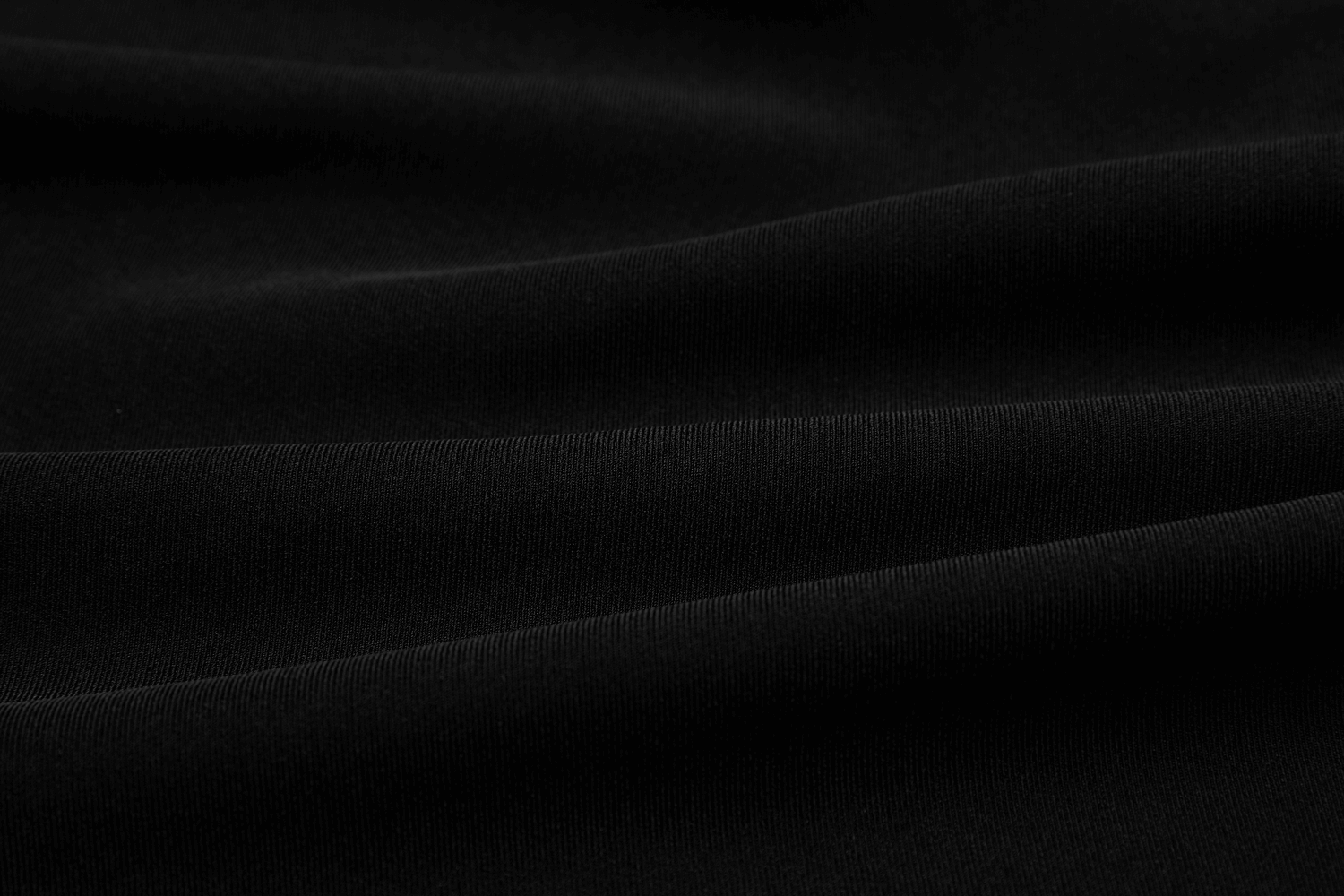 Close-up of smooth black fabric showing soft texture, perfect for high waist skirts and fashionable punk styles.