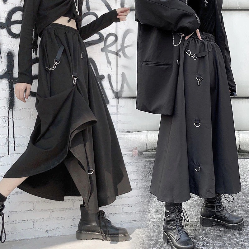 Punk style irregular black skirt with buckles, featuring an elastic waist and asymmetrical design for a trendy look.