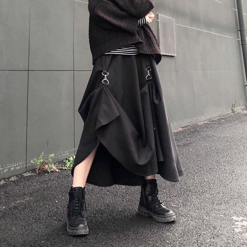 Punk style black irregular skirt with buckles, paired with combat boots for a trendy gothic look.