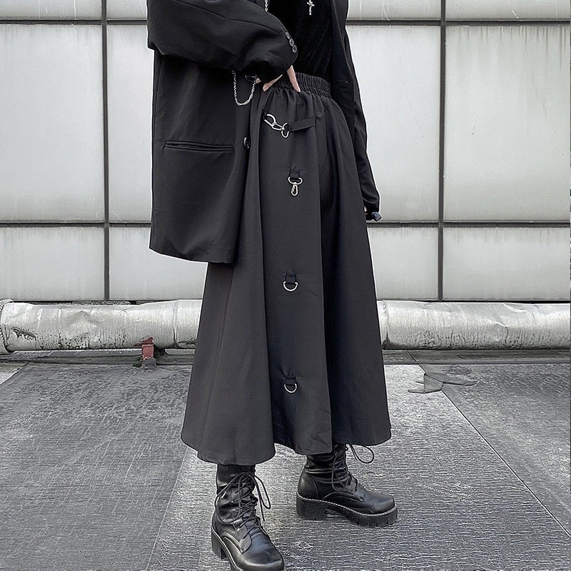 Punk style irregular black skirt with buckles and high waist, perfect for creating edgy outfits.