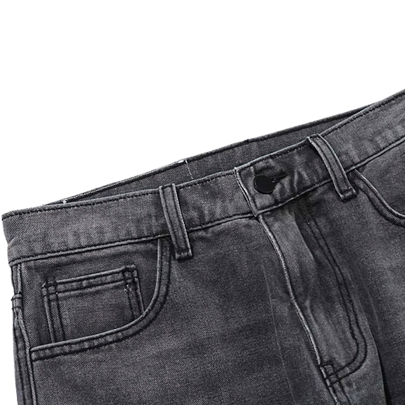 Punk style men's jeans with bone print and retro baggy fit in dark wash denim, highlighting waistband and front pockets.