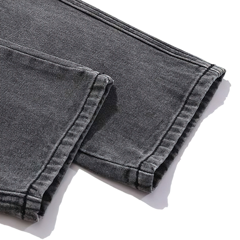 Close-up of punk style men's jeans with skeleton print, showcasing comfortable baggy retro denim in gray.