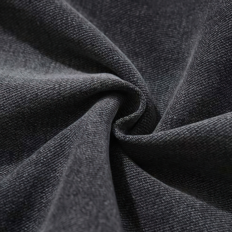 Close-up of dark denim fabric texture for punk style men's jeans.