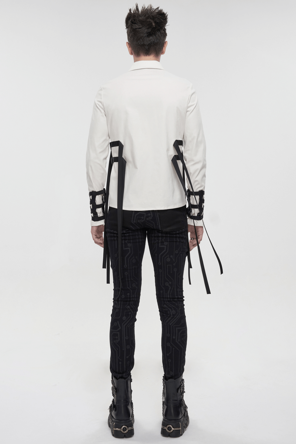 Back view of a punk style men's white long sleeve shirt with nylon straps and buckles, paired with stylish black skinny pants.
