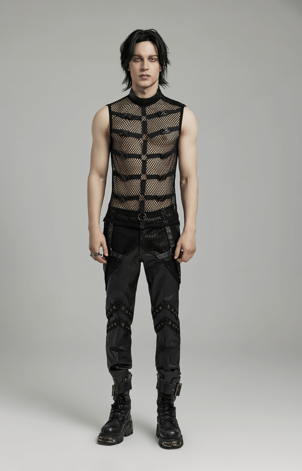 Punk style mesh vest with rubber buckles and iron rings, worn by a model in black pants, showcasing edgy fashion.