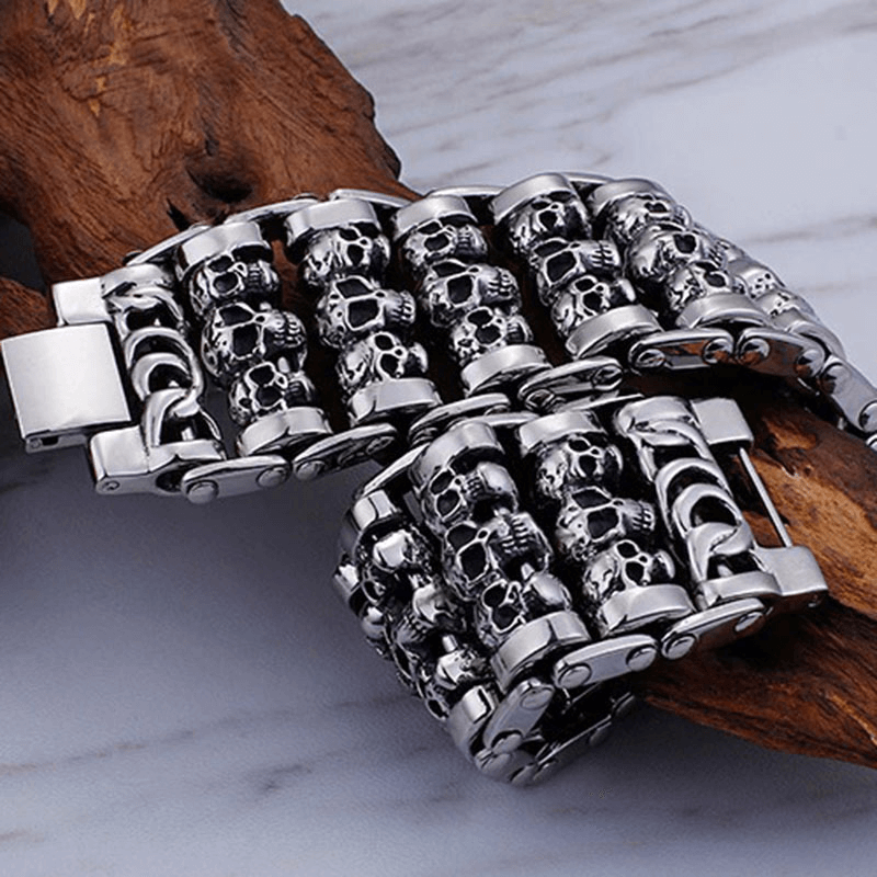 Punk style men's skull charm bracelet with multiple skull heads, made of 316 stainless steel, showcasing a trendy accessory.