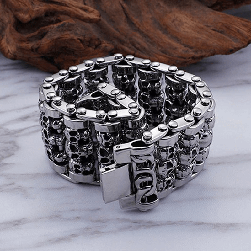 Punk style men's wide skull bracelet made of stainless steel with skull head charms for a bold accessory look.