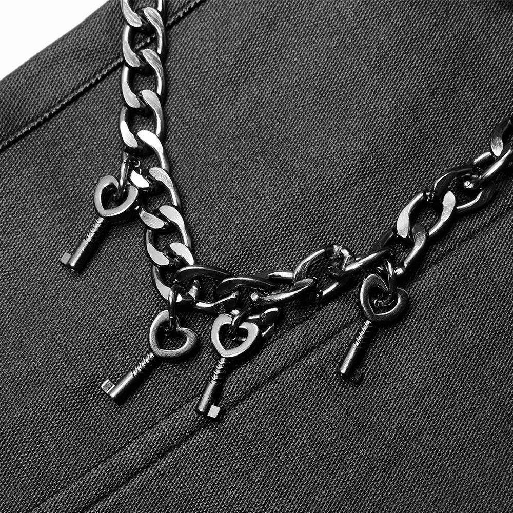 Close-up of punk-style black chain with keys, adding edgy style to leather pants.