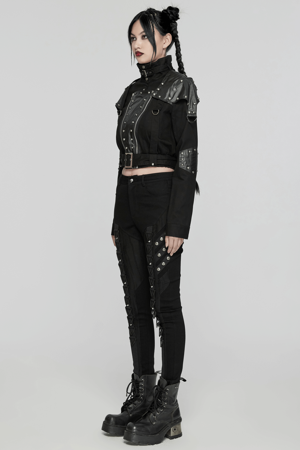 Edgy punk outfit featuring a black denim jacket and spliced jeans with shiny rivets and buckles for a rebellious look.
