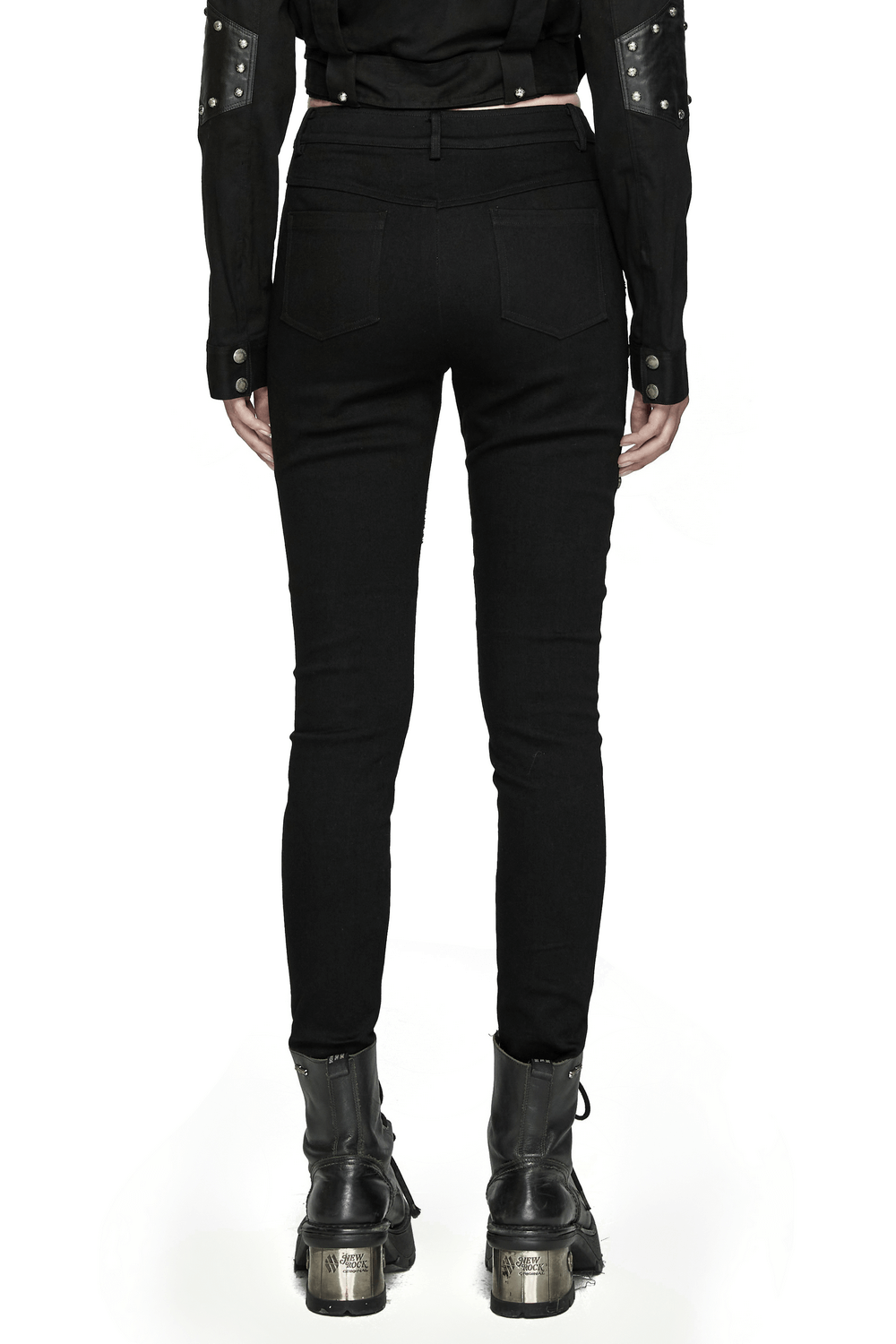 Back view of women's punk style riveted spliced denim jeans highlighting edgy details and a fitted silhouette.