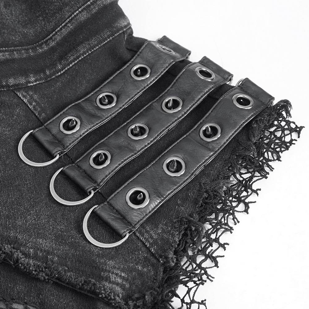 Close-up of punk style black studded vest with lace edges and metal rings, perfect for a gothic look.