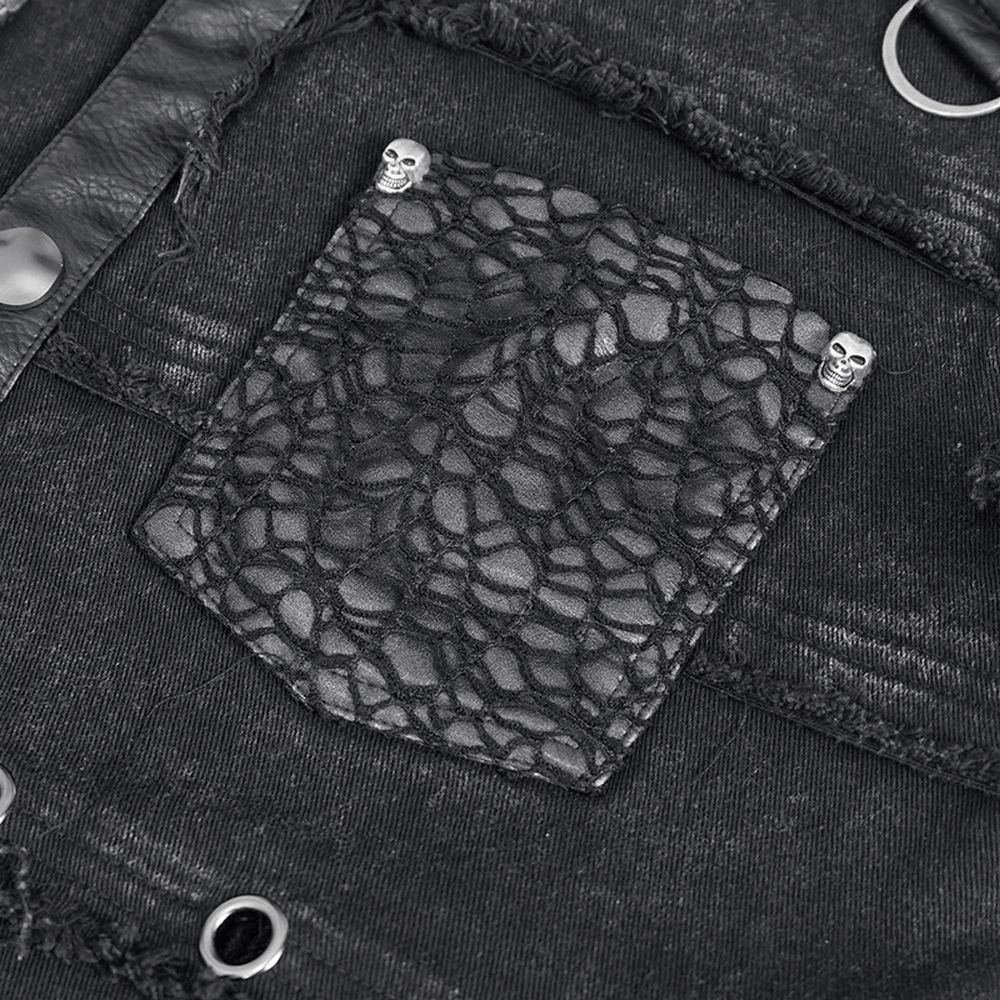 Close-up of a studded black vest pocket featuring lace detail and skull embellishments, ideal for gothic punk style.