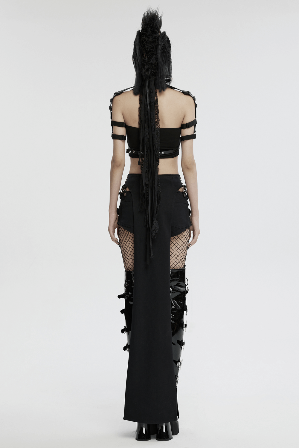 Punk-style outfit with synthetic leather bra harness and edgy accessories, showcasing bold circular design and unique strap details.