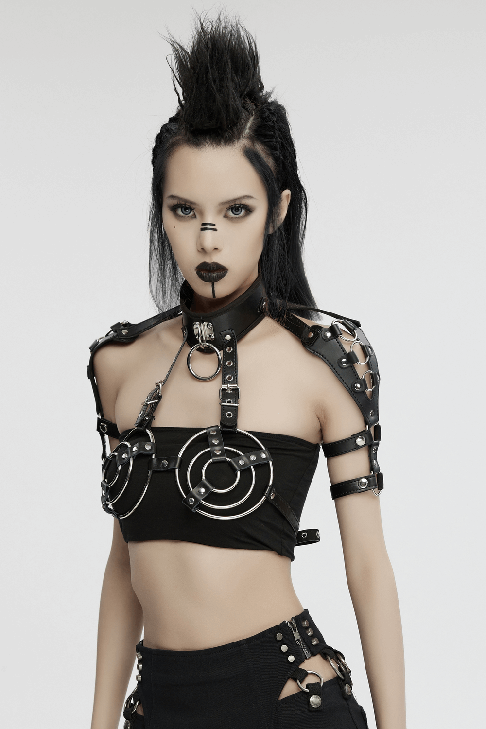 Edgy punk-style synthetic leather bra harness with circular rings and metal accents for a rebellious fashion statement.