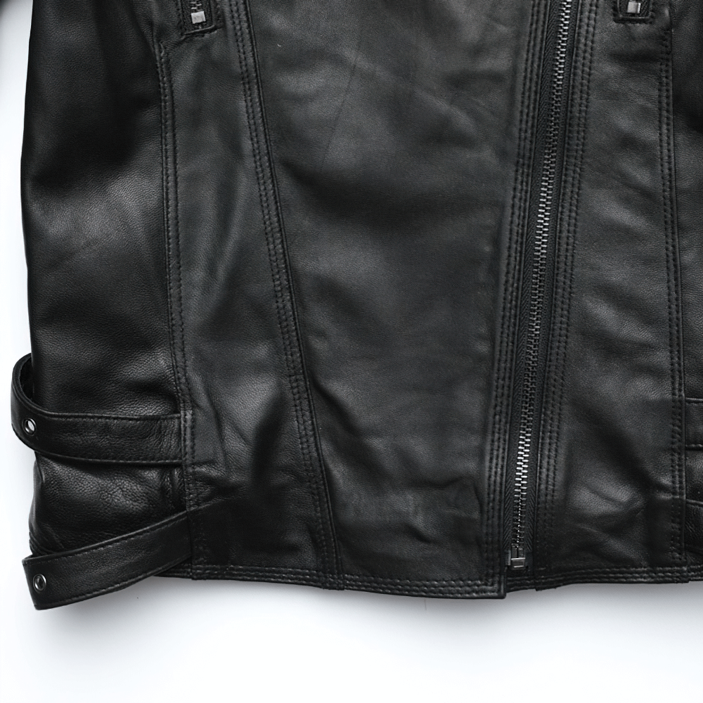 Close-up of a punk style women's black leather jacket with silver zippers and stylish details.