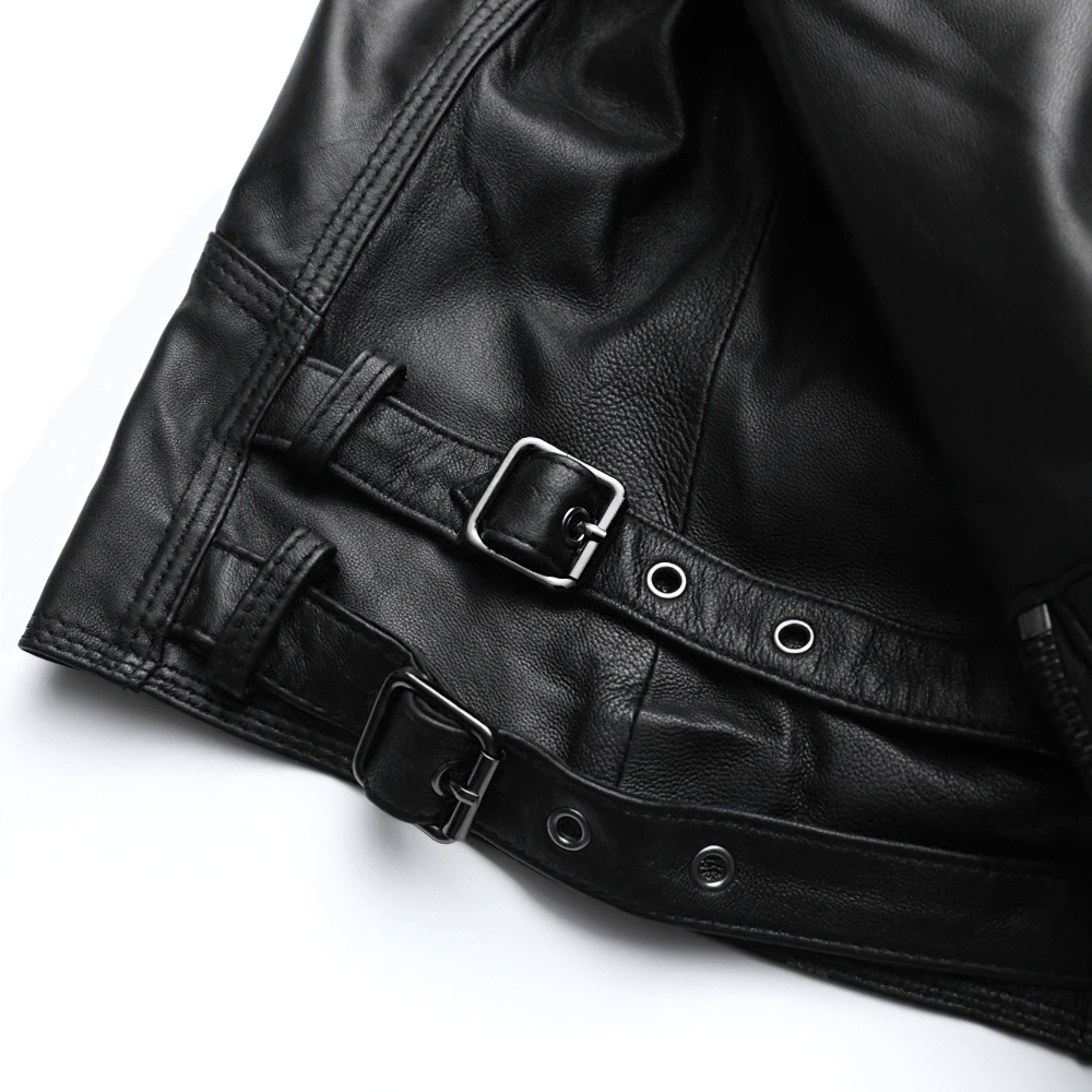 Close-up of a black women's leather jacket showcasing stylish silver zippers and buckle details.