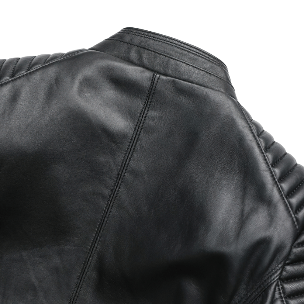 Close-up of the back of a women's black leather jacket with quilted design and stylish stitching details.
