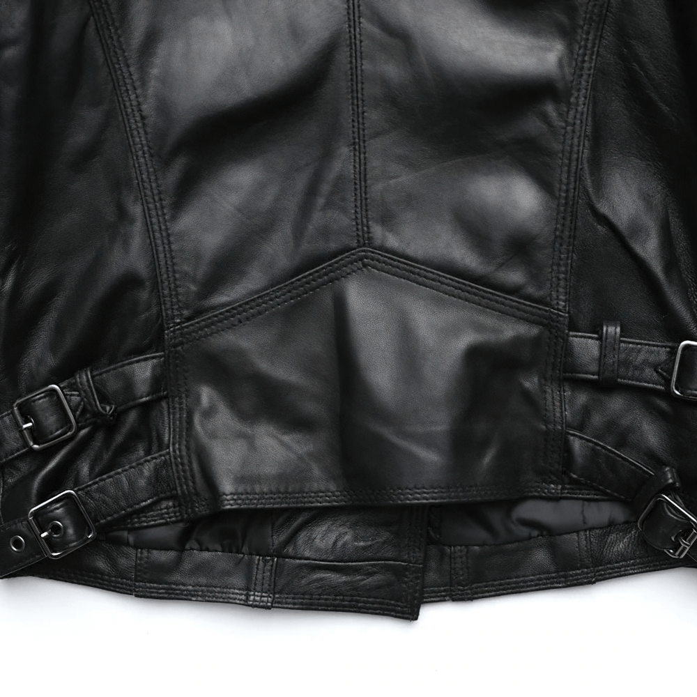Close-up of a black women's leather jacket featuring stylish silver zippers and buckle details, perfect for punk rock outfits.