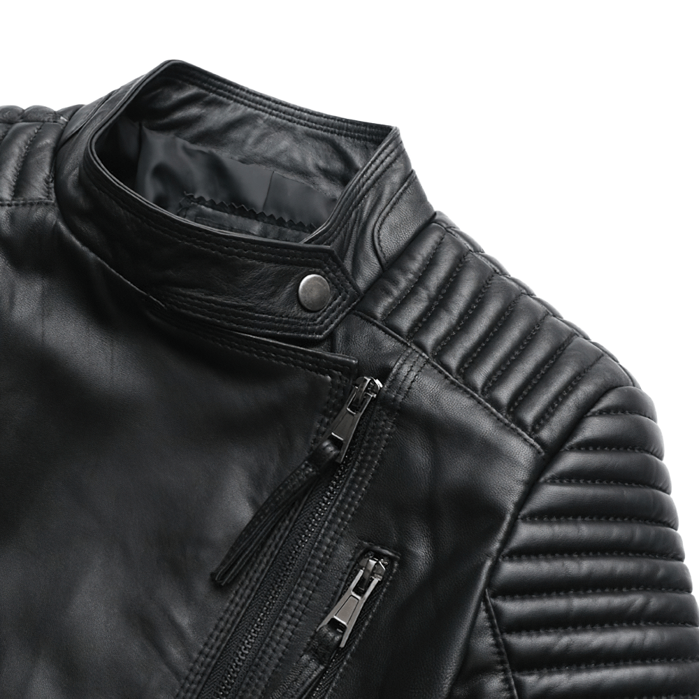 Close-up of a stylish women's black leather jacket with silver zippers and quilted shoulder design.