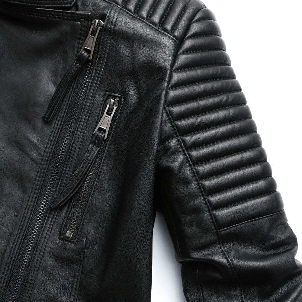 Close-up of black women's genuine leather jacket featuring stylish silver zippers and ribbed shoulder detailing.