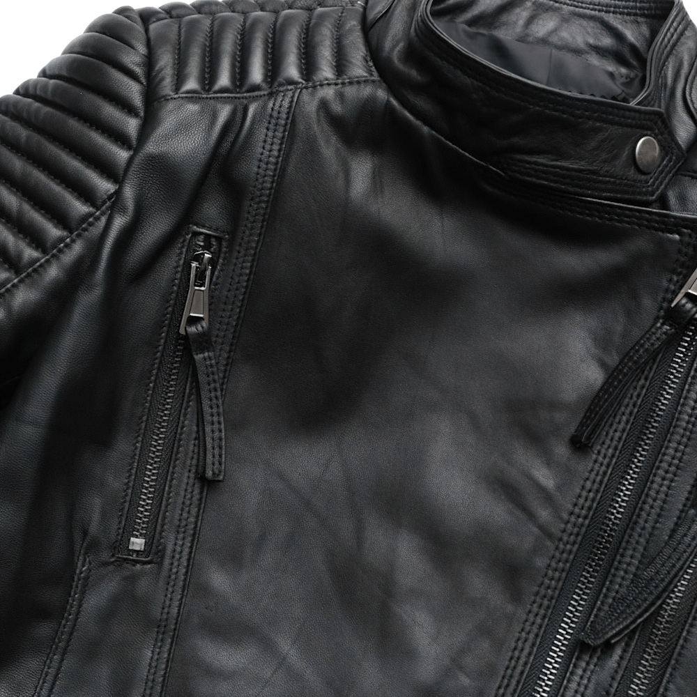 Close-up of a black women's leather jacket with stylish zippers and ribbed detailing, perfect for punk rock outfits.