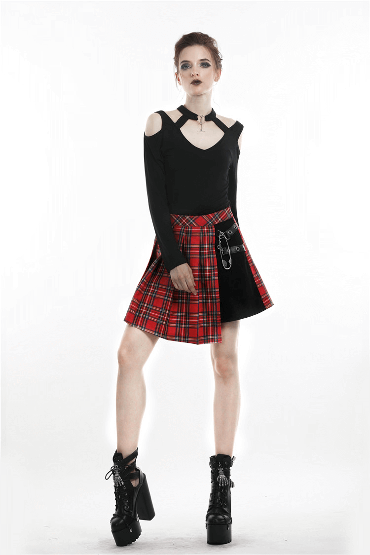 Edgy red and black plaid mini skirt with safety pin detailing for a punk rock look.
