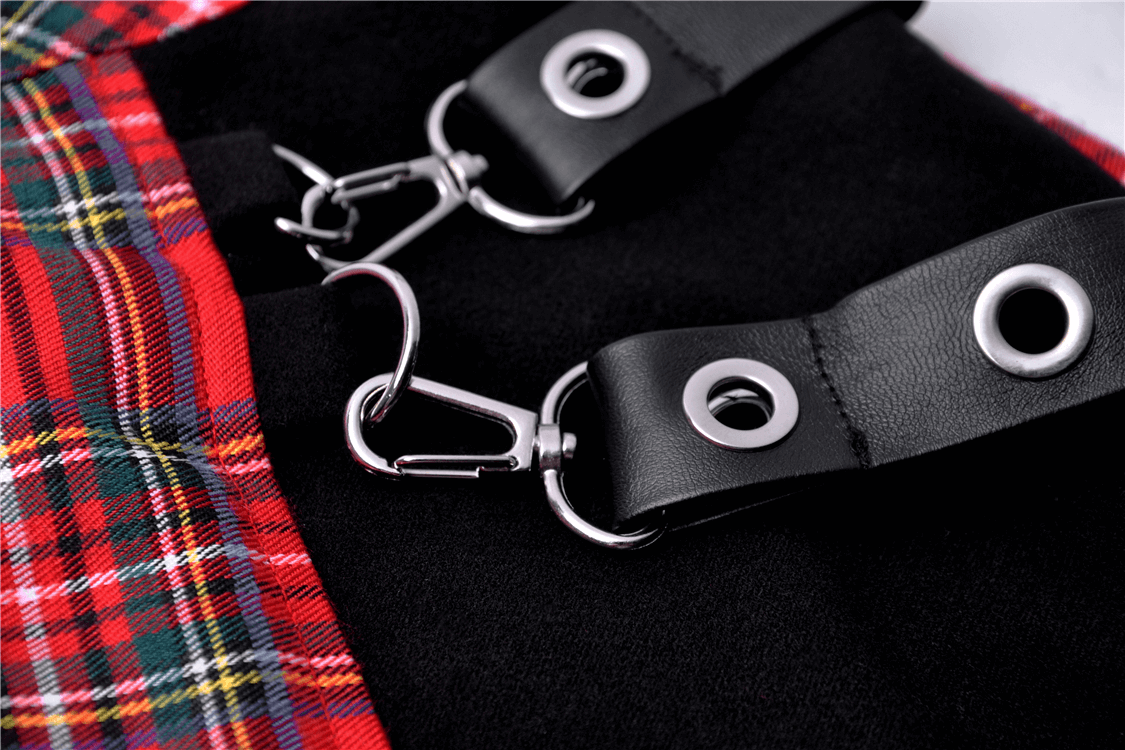 Close-up of punk plaid mini skirt with metal clips and black straps, perfect for adding edge to your outfit.