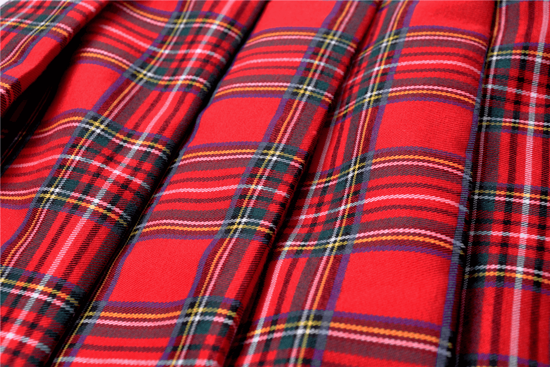 Close-up of red and black plaid fabric, perfect for a punk rock mini skirt with edgy style.