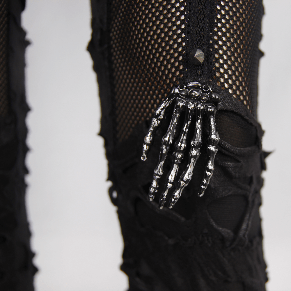 Close-up of punk tattered leggings with skeletal detail, showcasing black gothic style and edgy ripped design.