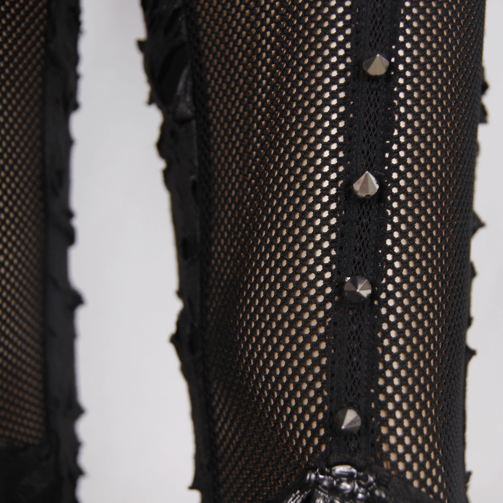 Close-up of gothic punk leggings featuring black mesh and decorative studs, perfect for edgy women's fashion.