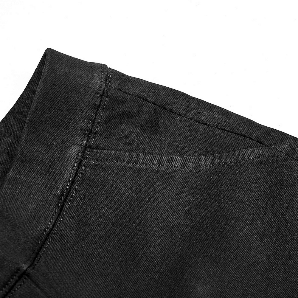 Close-up of the sleek waistband of punk techwear faux leather leggings with detailed stitching.