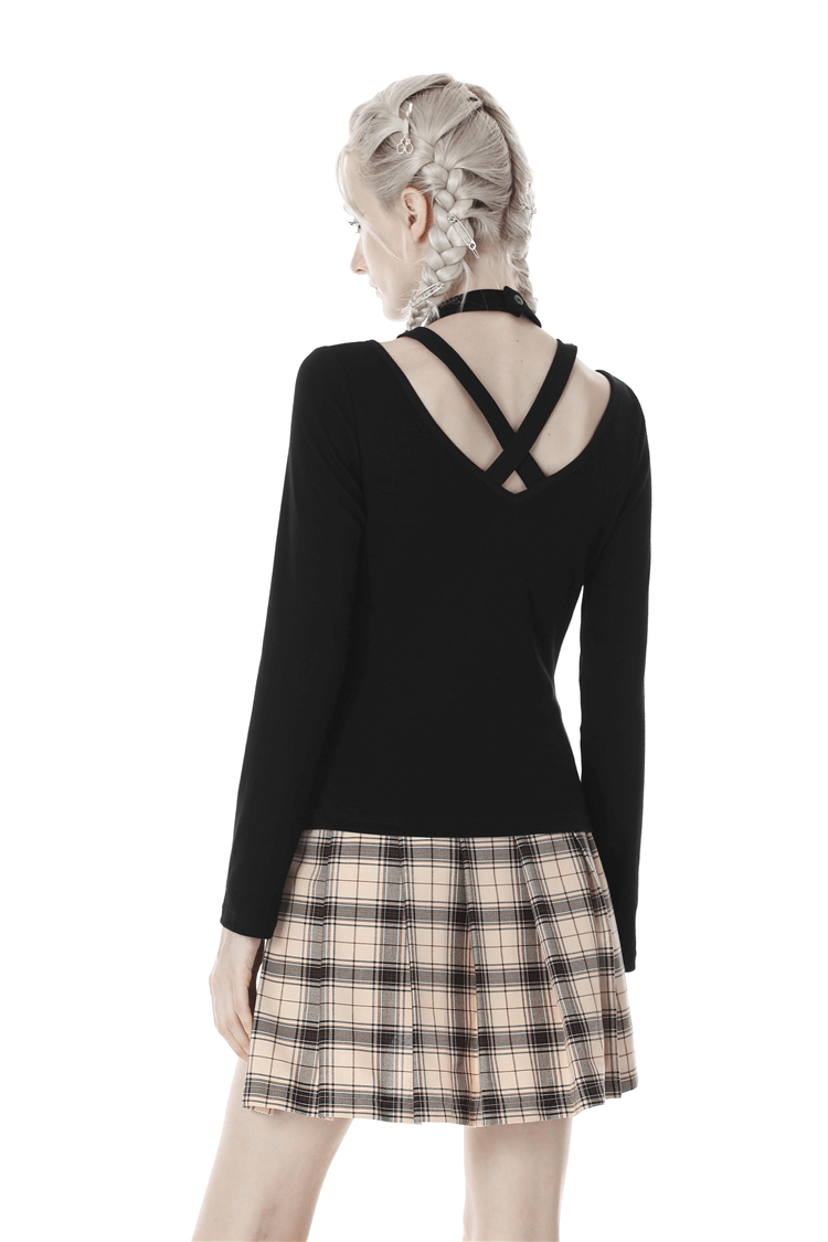 Back view of a woman wearing a punk black long sleeve top with a plaid skirt, showcasing edgy cross-back straps.