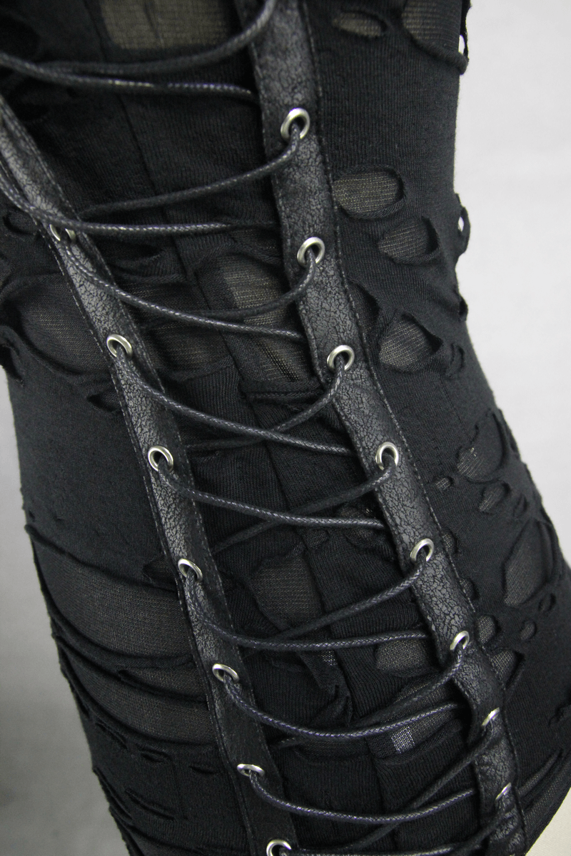 Close-up of punk women's black tank top showcasing lace-up detailing and irregular hole design on the side.