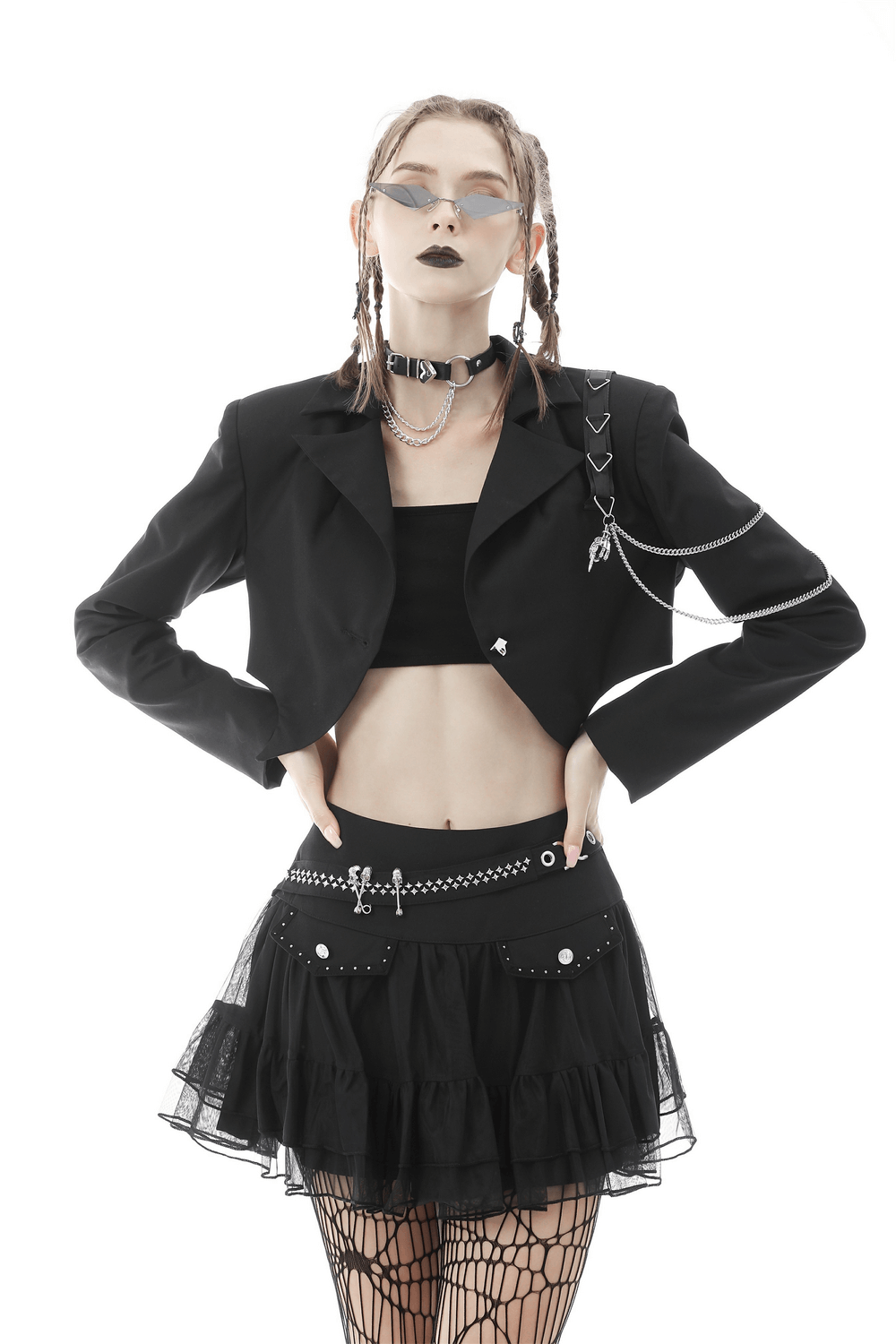 Punk women's black crop jacket with chain embellishments, paired with a stylish black skirt and accessories.