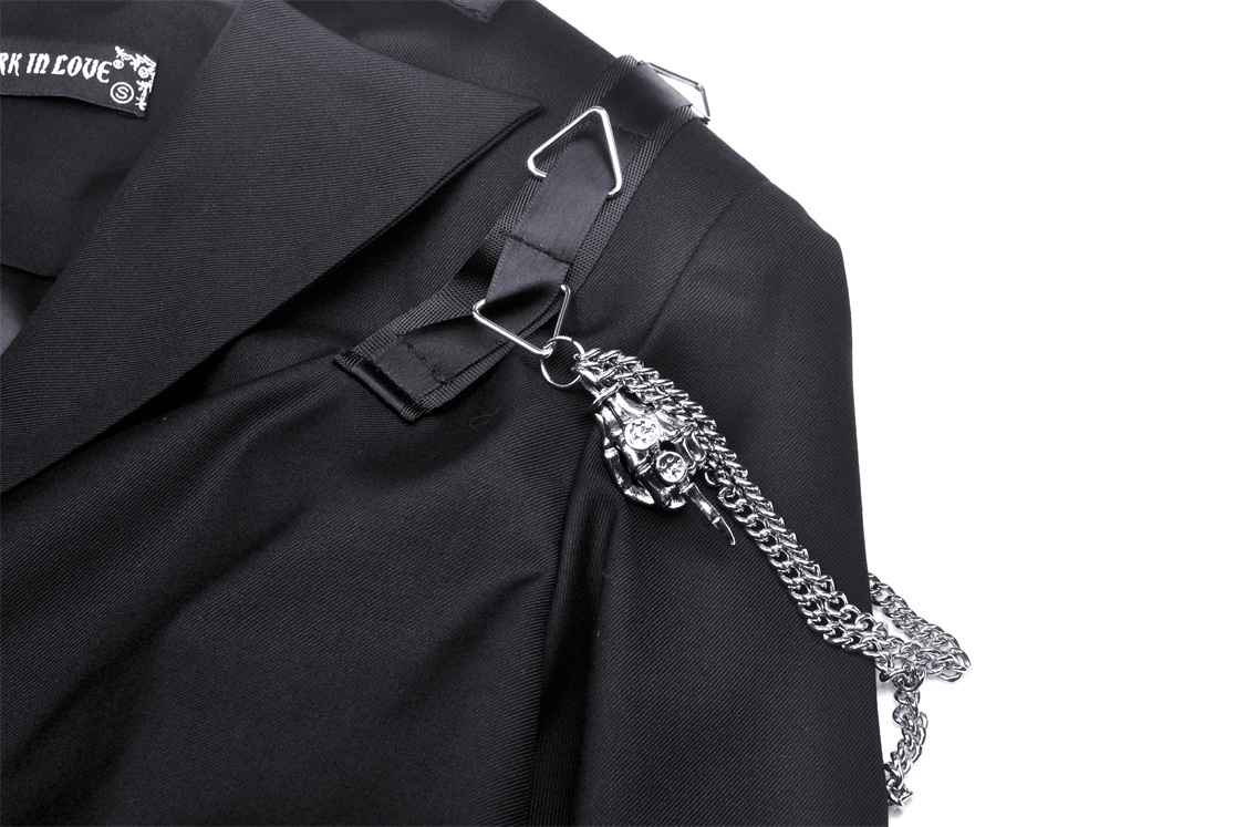 Close-up of a punk women's cropped jacket with chain embellishments and edgy hardware details.