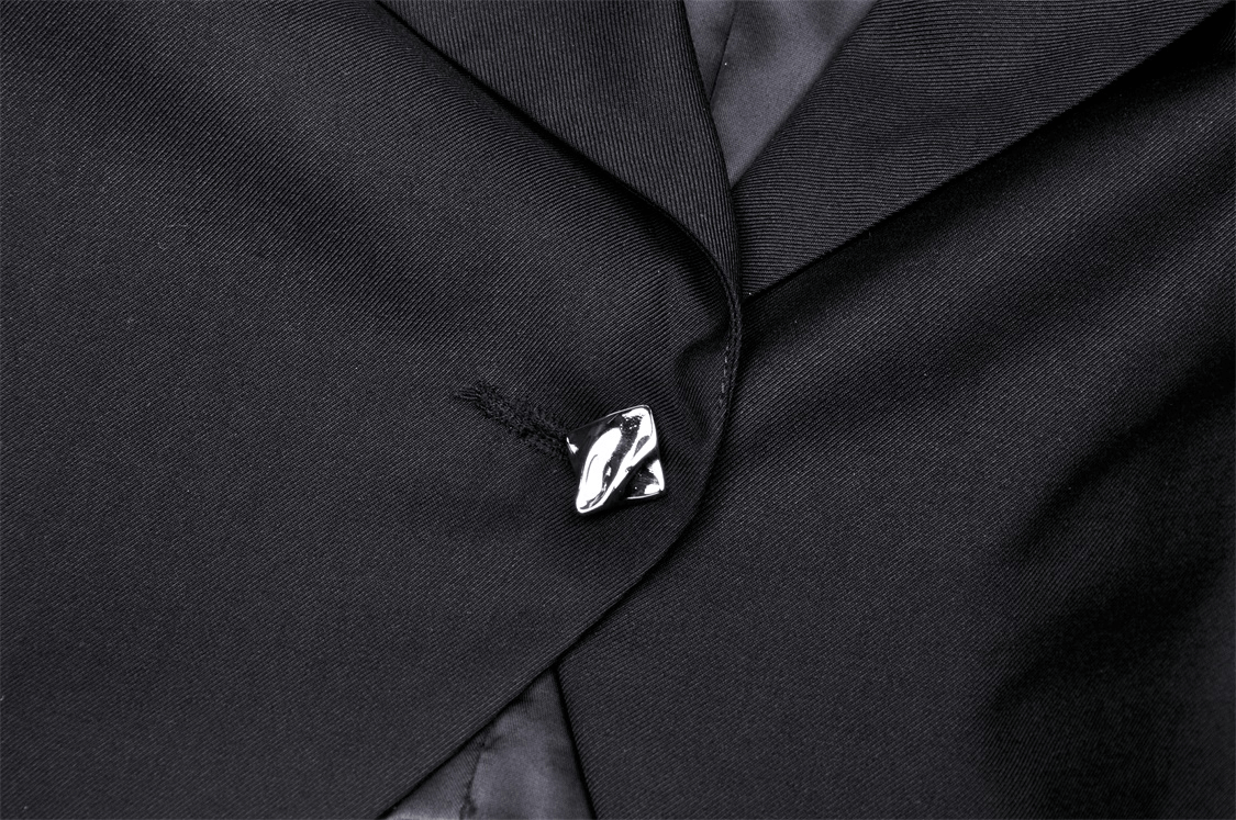 Close-up of a black punk women's crop jacket with a stylish silver chain embellishment detail.