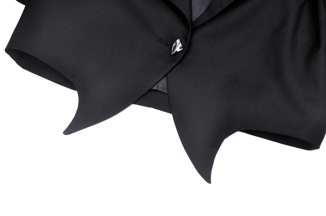 Black cropped jacket with edgy chain details, perfect for a punk goth look and bold fashion statement.