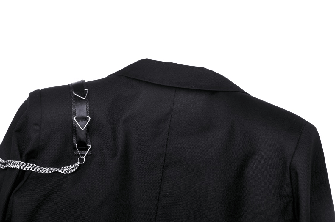 Back view of a black punk crop jacket with edgy chain embellishments and triangular hardware.