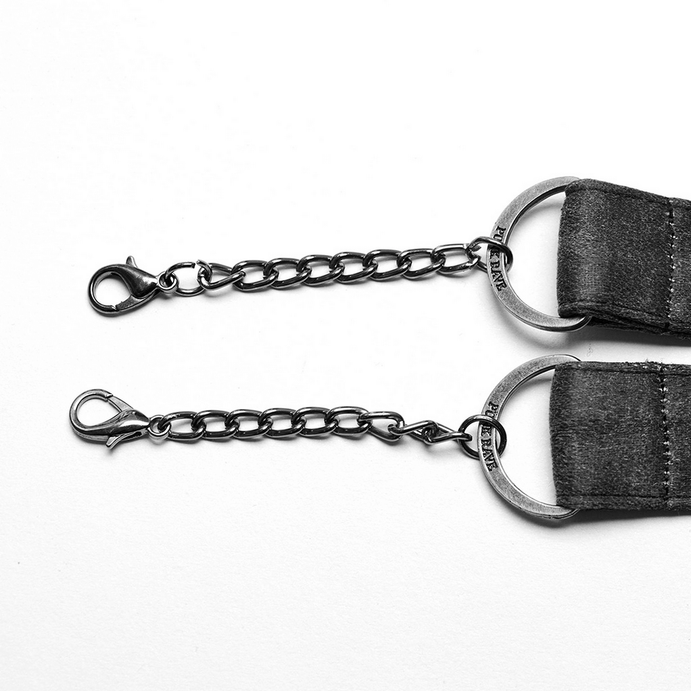 Close-up of black double strap choker chain with hooks and rings, showcasing edgy punk style.