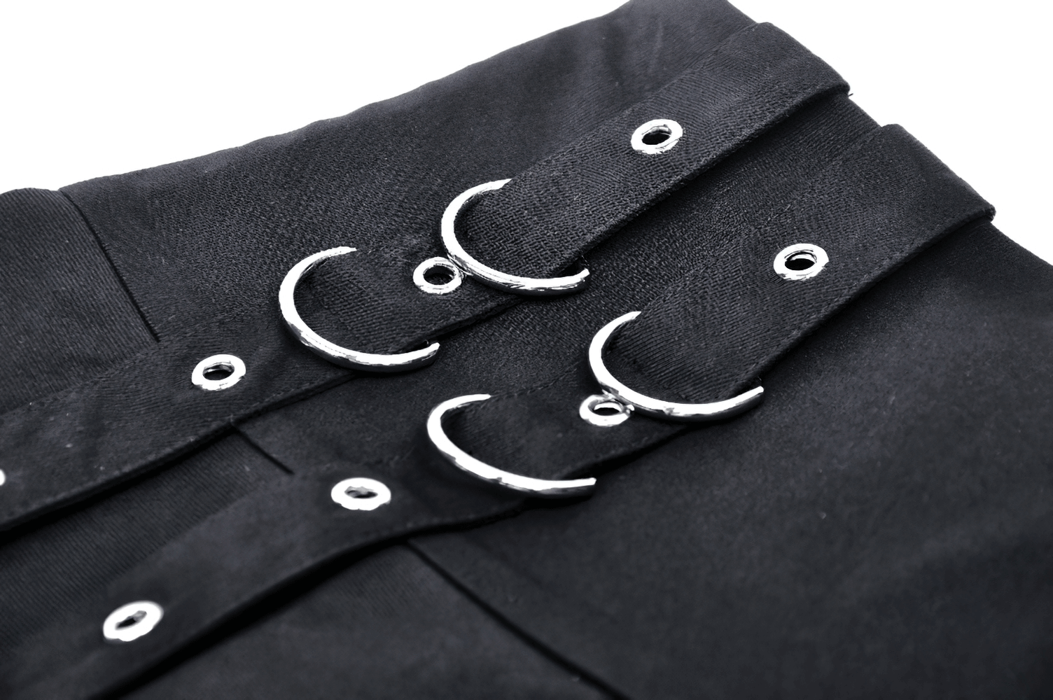Close-up of black punk mini skirt featuring silver o-rings and button details, perfect for edgy fashion lovers.