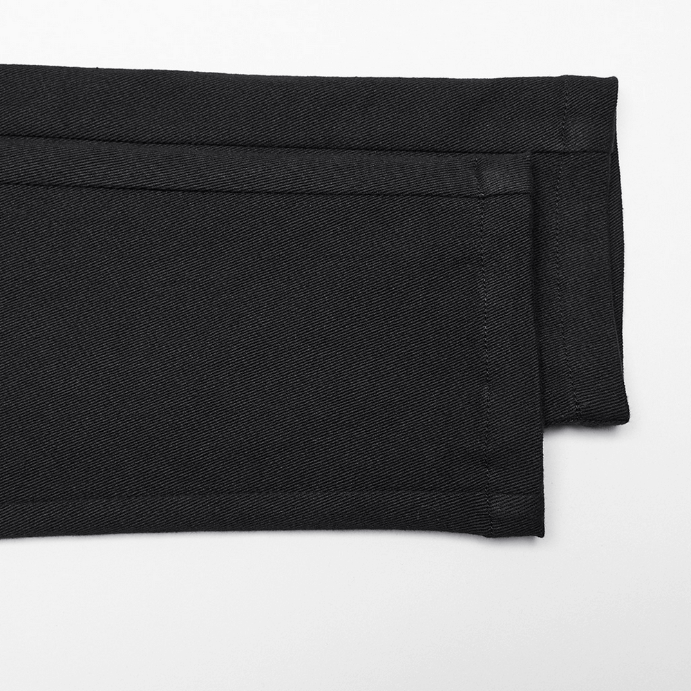 Close-up of black micro elastic twill fabric, showing the texture of punk women's trousers.