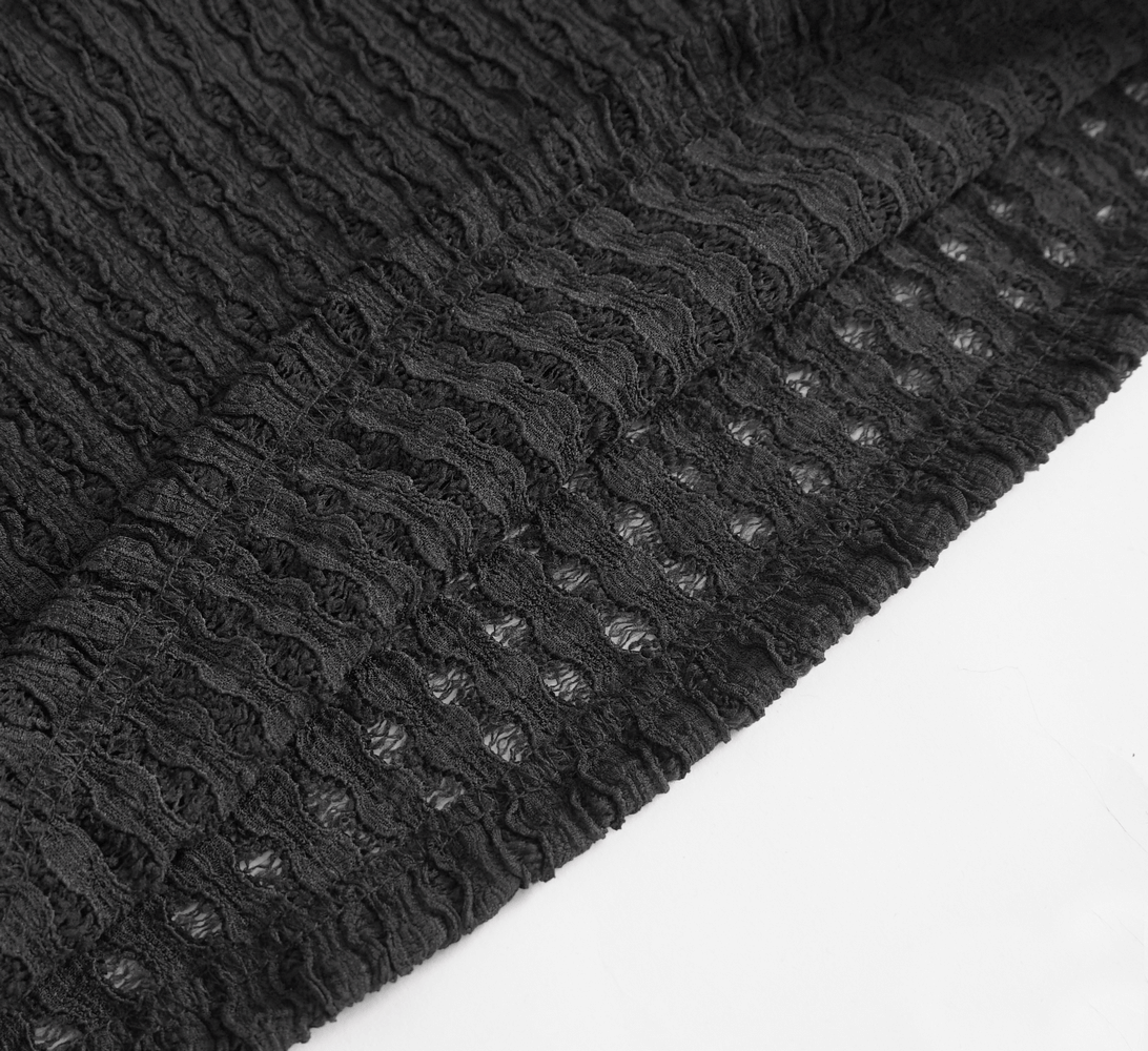 Close-up of black textured fabric with mesh detailing, perfect for a punk-style t-shirt with edgy flair.