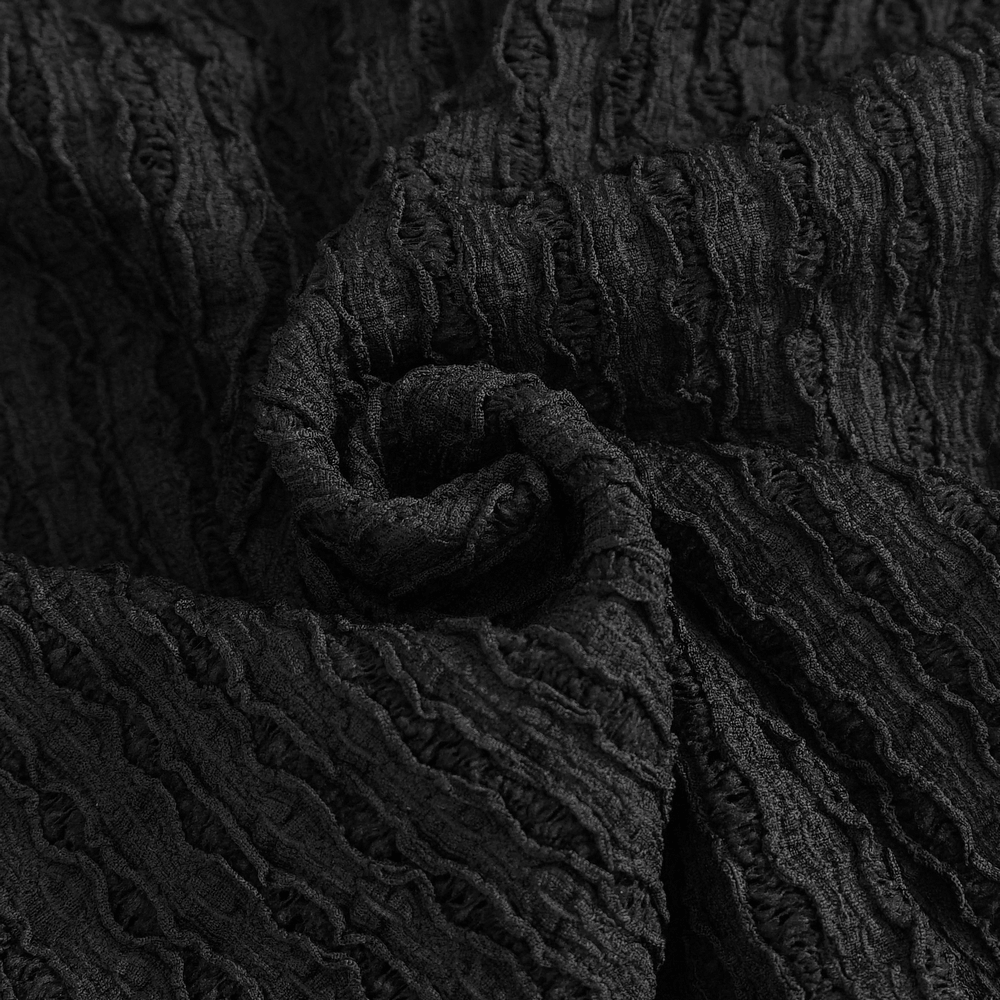 Black textured fabric showcasing wavy patterns, ideal for edgy fashion designs and stylish apparel.
