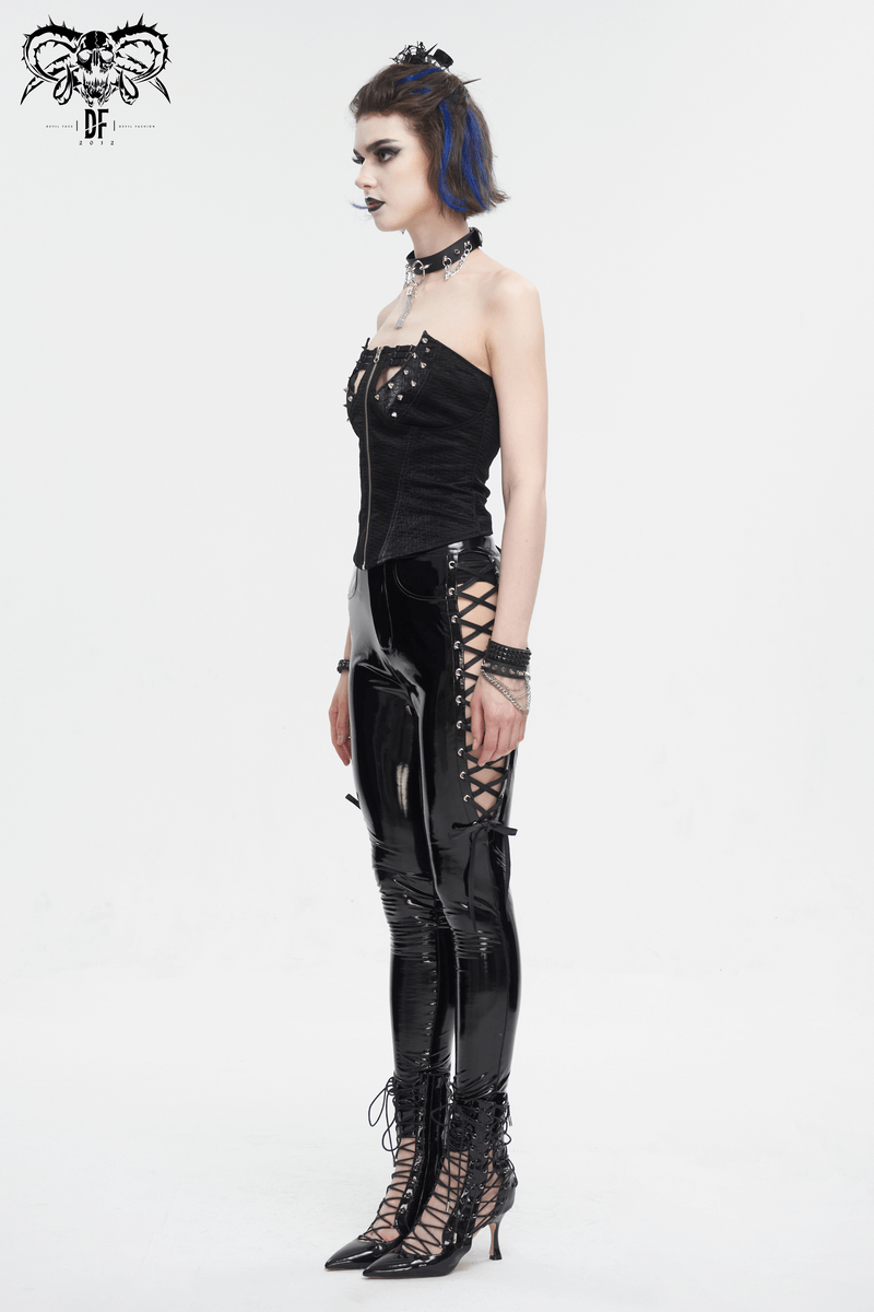 Edgy punk woman in a zipper front overbust corset with rivets, styled with bold accessories and high fashion pants.