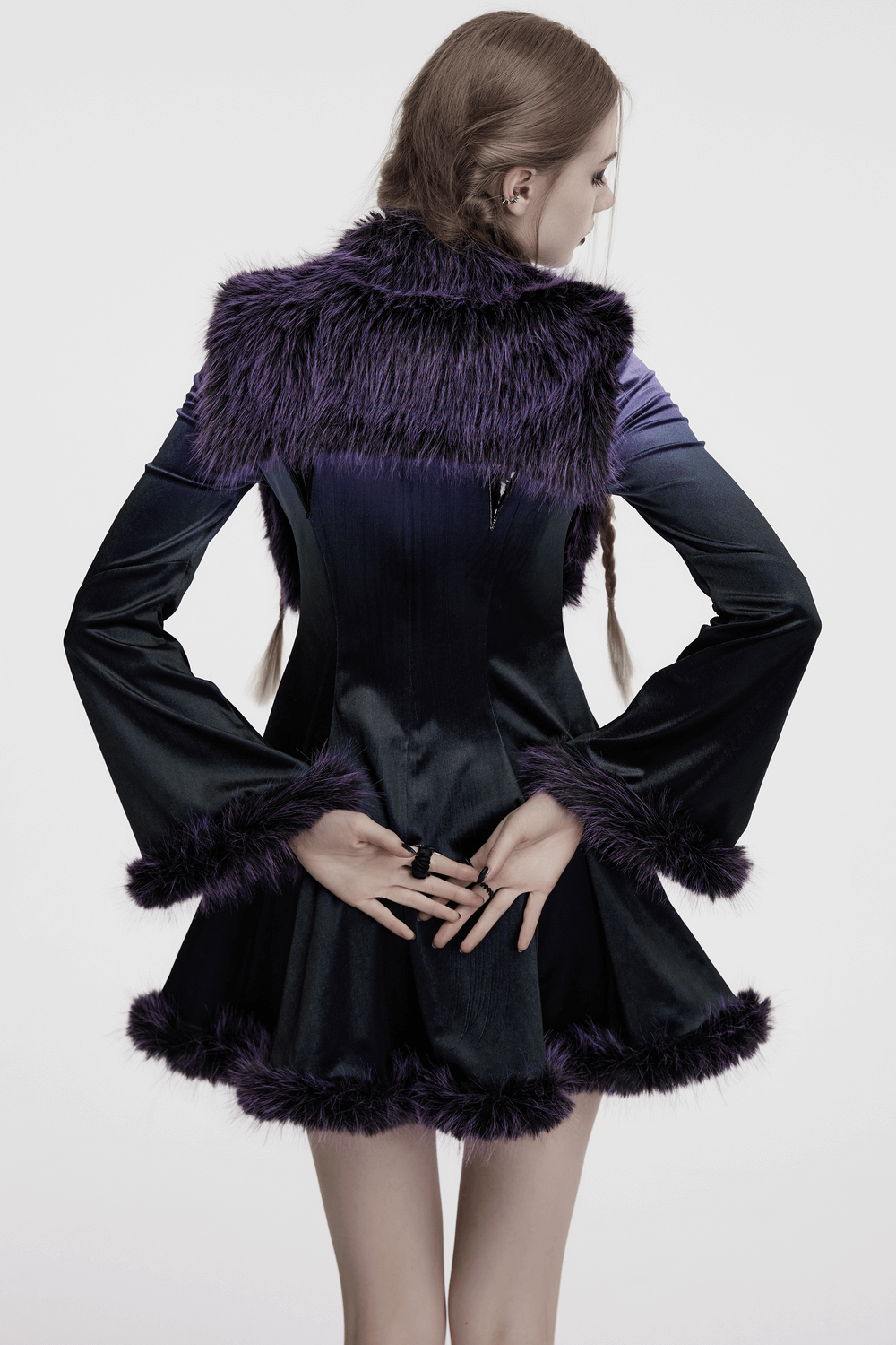 Back view of a purple faux fur capelet with horn detail, showcasing wide sleeves and a stylish cut.