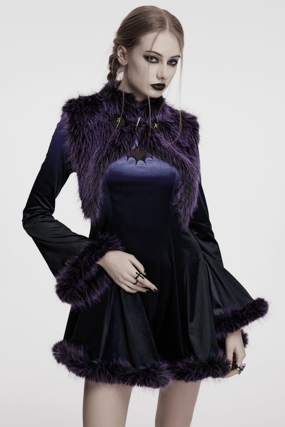 Purple faux fur capelet with horn detail and buttons, creating a bold gothic look in a stylish design.