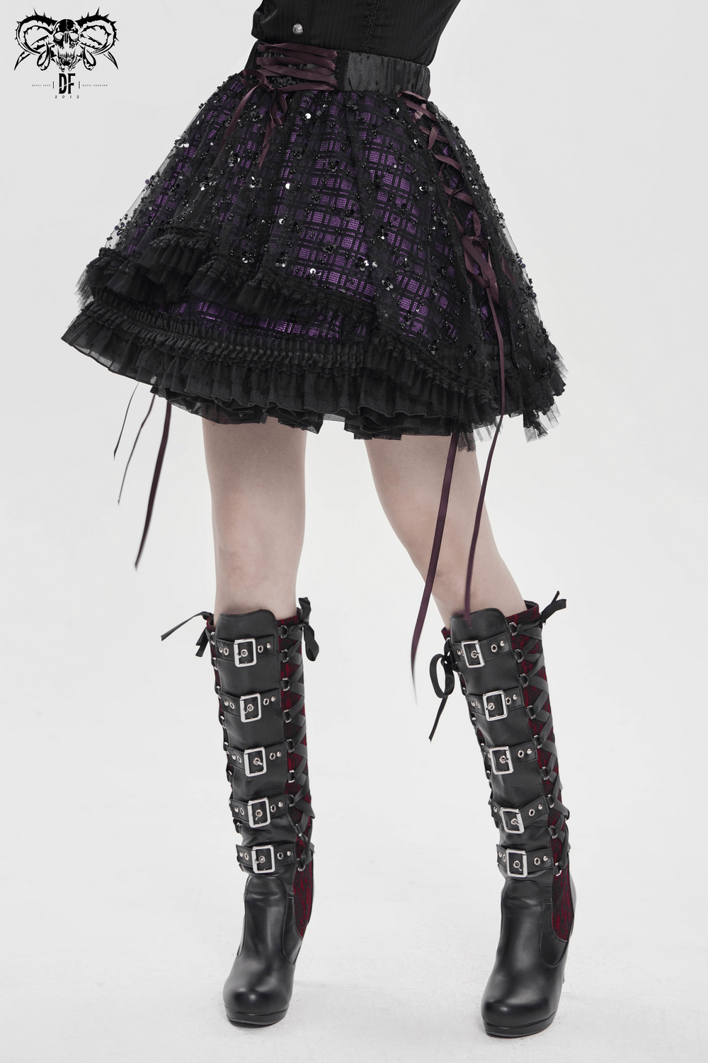 Purple Gothic Tulle Skirt with Lace Up Ribbon Trim styled with black sequin boots for a dramatic gothic look.